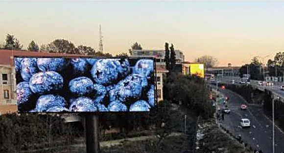 Large format LED billboard at dusk