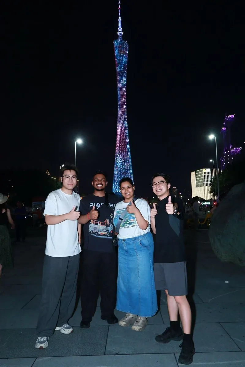 Partners visiting Canton Tower at night