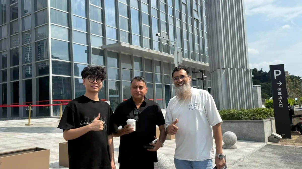 Partners outside the showroom building